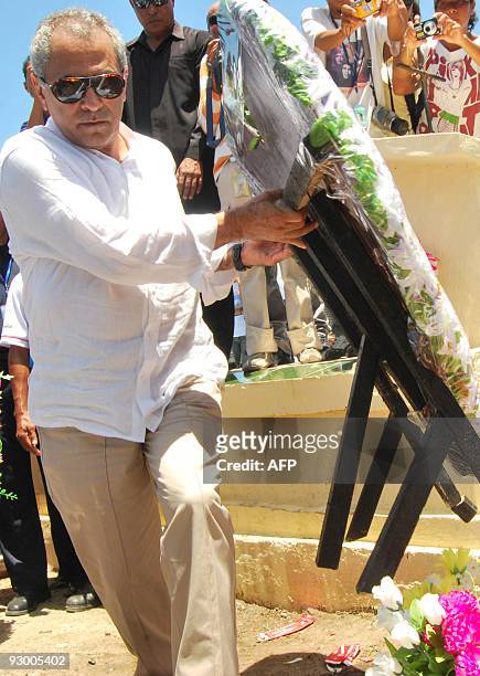 East Timor President Jose Ramos Horta carries a wreath to the tomb of slain activist Sebastiao Gomes during a memorial for the 1991 massacre, in the...