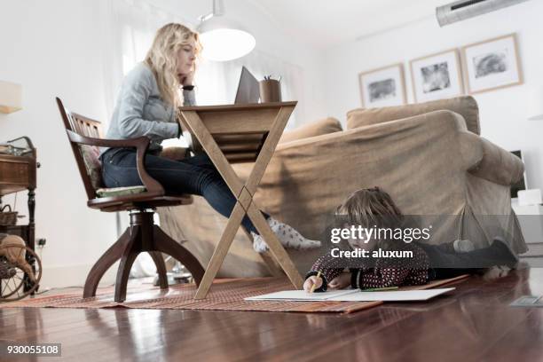 mother working while child is drawing at home - ignoring child stock pictures, royalty-free photos & images