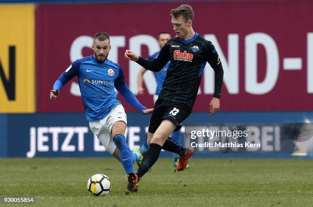 Fabian Holthaus of Rostock battles for the ball with Sebastian Schonlau of Paderborn during the 3.Liga match between FC Hansa Rostock and SC...