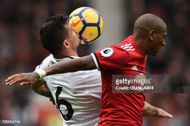 Liverpool's Croatian defender Dejan Lovren goes up against Manchester United's English midfielder Ashley Young during the English Premier League...