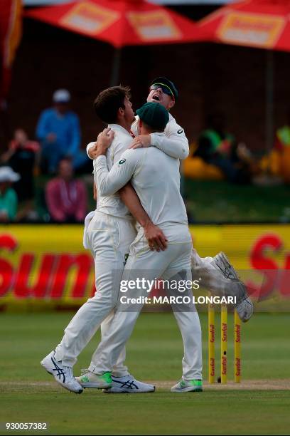 Australia bowler Mitchell Marsh is congratulated after taking the wicket of South Africa batsman Theunis de Bruyn during the second days play of the...