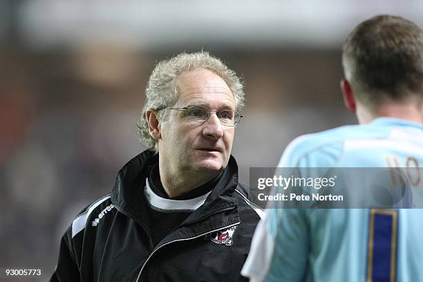 Northampton Town assistant manager Malcolm Crosby talks to Andy Holt during the Johnstone's Paint Trophy Southern Area Quarter Final Match between MK...