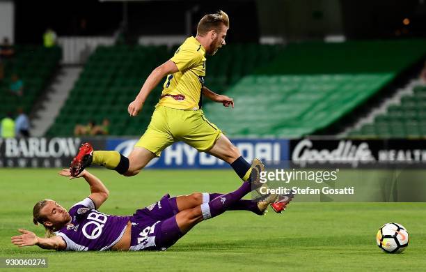 Joseph Mills of the Glory and Connor Pain of the Mariners collide during the round 22 A-League match between the Perth Glory and the Central Coast...
