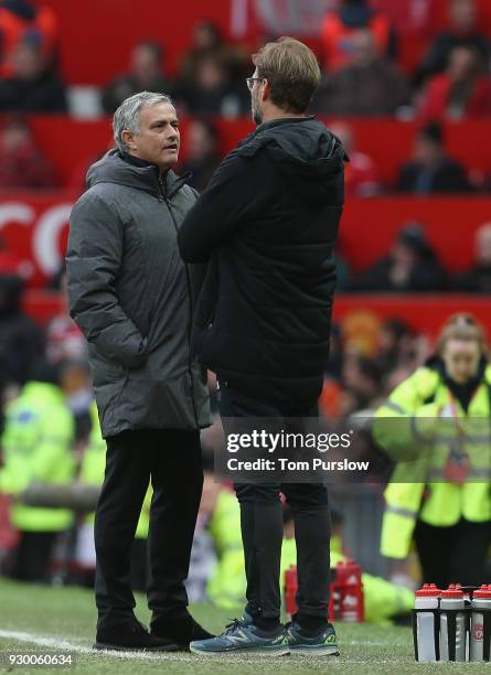 Manager Jose Mourinho of Manchester United speaks to Manager Jurgen Klopp of Liverpool during the Premier League match between Manchester United and...