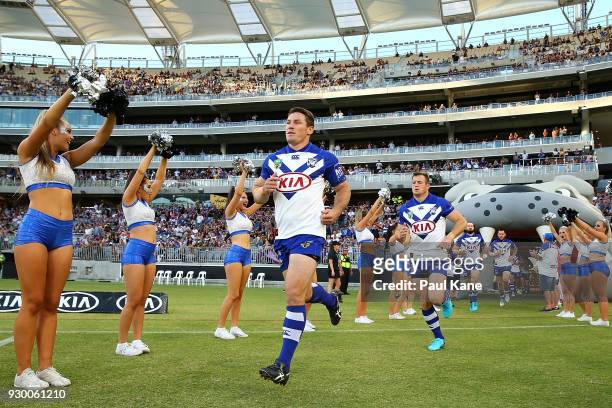 Josh Jackson of the Bulldogs leads the team onto the field during the round one NRL match between the Canterbury Bulldogs and the Melbourne Storm at...