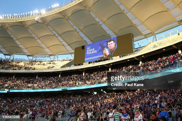Spectators stand to pay their respects to the late Steve Folkes before the round one NRL match between the Canterbury Bulldogs and the Melbourne...