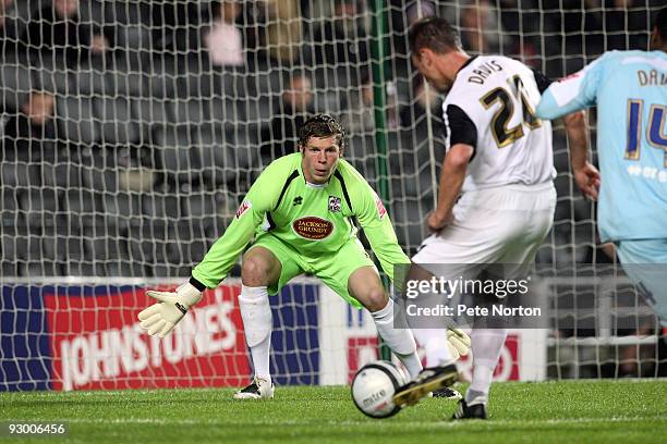 Sol Davis of MK Dons prepares to shoot for goal as Chris Dunn of Northampton Town looks on during the Johnstone's Paint Trophy Southern Area Quarter...