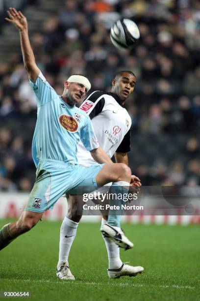 Andy Holt of Northampton Town contests the ball with Jermaine Easter of MK Dons during the Johnstone's Paint Trophy Southern Area Quarter Final Match...