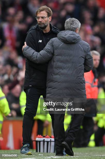 Jurgen Klopp, Manager of Liverpool speaks to Jose Mourinho, Manager of Manchester United after the Premier League match between Manchester United and...