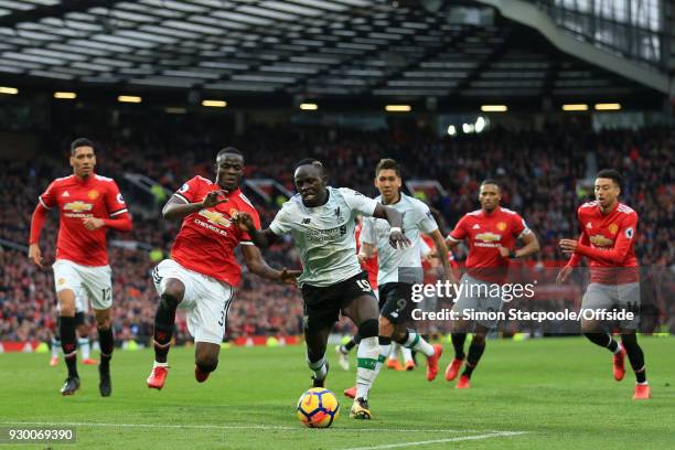 Sadio Mane of Liverpool gets away from Eric Bailly of Man Utd as he struggles get a late shot in during the Premier League match between Manchester...