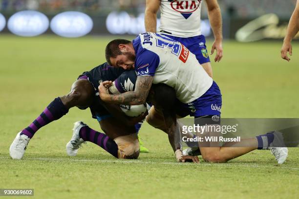 Suliasi Vunivalu of the Storm is tackled by David Klemmer of the Bulldogs during the round one NRL match between the Canterbury Bulldogs and the...