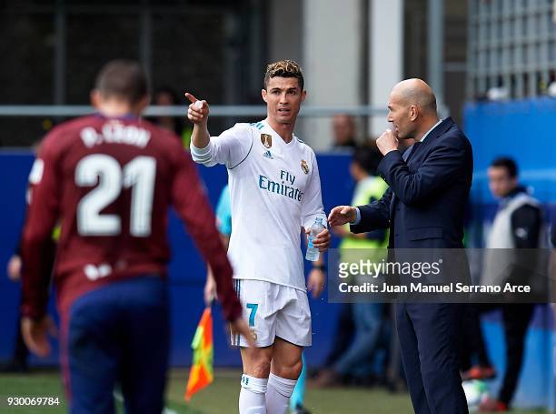 Coach Zinedine Zidane of Real Madrid CF gives instructions to his player Cristiano Ronaldo during the La Liga match between Eibar and Real Madrid at...