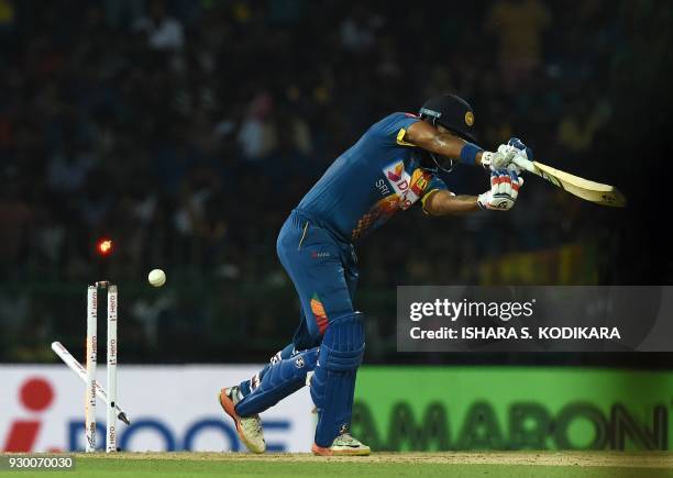 Sri Lankan cricketer Danushka Gunathilaka gets dismissed by Bangladesh cricketer Mustafizur Rahman during the third Twenty20 international cricket...