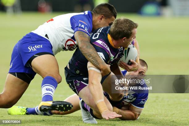 Tim Glasby of the Storm is tackled by Kieran Foran of the Bulldogs during the round one NRL match between the Canterbury Bulldogs and the Melbourne...