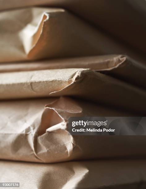 stack of manila envelopes or packages - manila envelope stock pictures, royalty-free photos & images