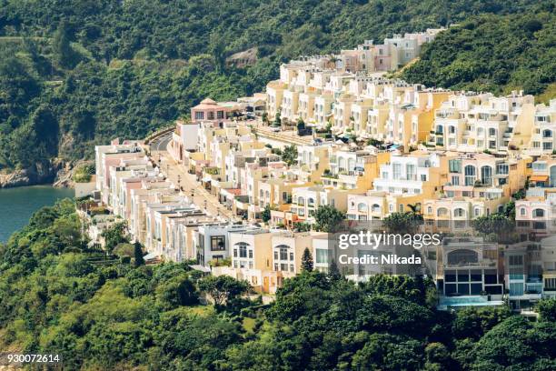 hong kong apartment buildings in nature - howse peak stock pictures, royalty-free photos & images