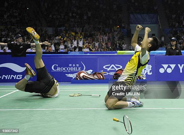China's Cai Yun and Fu Haifeng celebrate after winning over South Korea's Jung Jae Sung and Lee Yong Dae during the men's doubles final match at the...