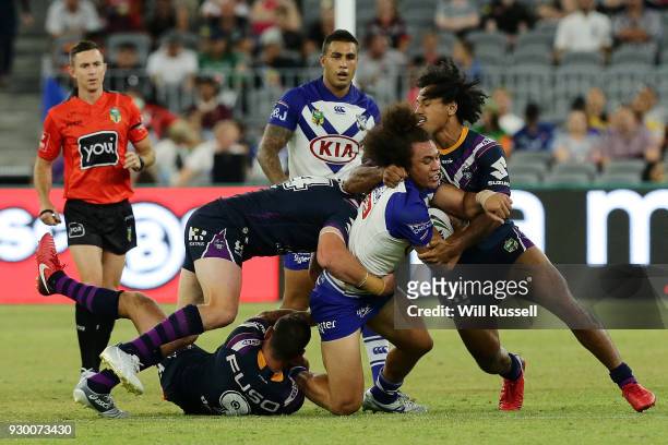 Raymond Faitala-Mariner of the Bulldogs is tackled during the round one NRL match between the Canterbury Bulldogs and the Melbourne Storm at Optus...