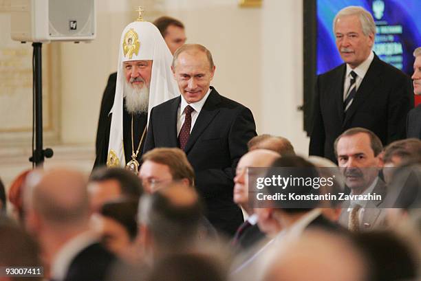 Russian Orthodox Patriarch Kirill and Prime Minister Vladimir Putin arrive for an annual address given by Russian President Dmitry Medvedev to the...