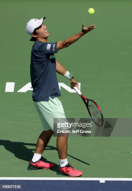 Yoshihito Nishioka of Japan tosses the ball up before serving to Marcos Baghdatis of Cyprus during the BNP Paribas Open at the Indian Wells Tennis...