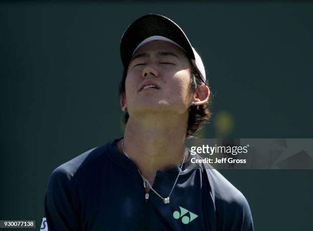 Yoshihito Nishioka of Japan reacts after losing a point to Marcos Baghdatis of Cyprus during the BNP Paribas Open at the Indian Wells Tennis Garden...