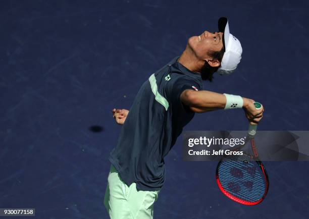 Yoshihito Nishioka of Japan serves to Marcos Baghdatis of Cyprus during the BNP Paribas Open at the Indian Wells Tennis Garden on March 9, 2018 in...