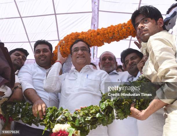 Newly-elected Delhi Youth Congress President Vikas Chhikara and DPCC president Ajay Maken being garlanded during an oath-taking ceremony at the DPCC...