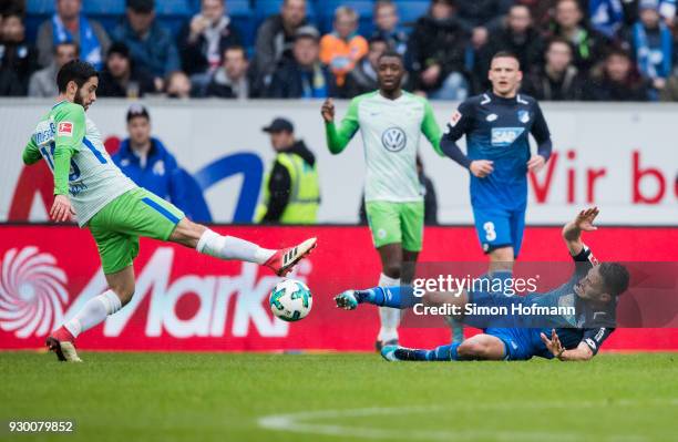 Lukas Rupp of Hoffenheim is challenged by Yunus Malli of Wolfsburg during the Bundesliga match between TSG 1899 Hoffenheim and VfL Wolfsburg at...
