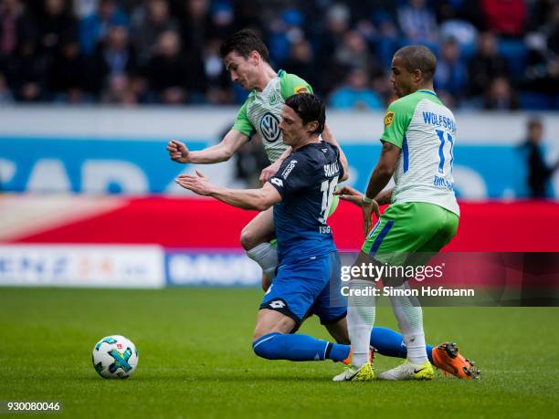 Nico Schulz of Hoffenheim is challenged by Paul Verhaegh of Wolfsburg and Daniel Didavi of Wolfsburg during the Bundesliga match between TSG 1899...