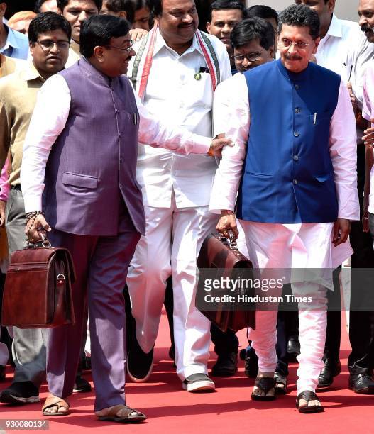 State Finance Minister Sudhir Mungantiwar and Minister for State for Finance Deepak Kesarkar stand for a photo opportunity before presenting the...