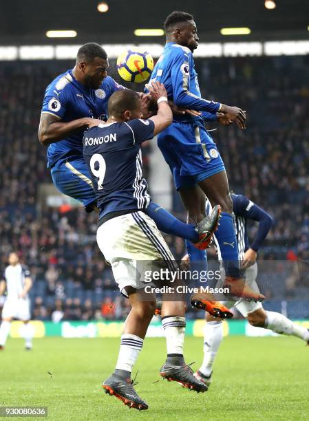 Jose Salomon Rondon of West Bromwich Albion battles for a header with Wes Morgan and Demarai Gray of Leicester City during the Premier League match...