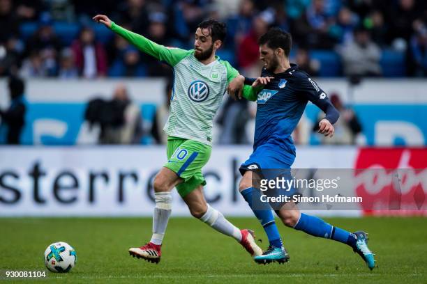 Yunus Malli of Wolfsburg is challenged by Florian Grillitsch of Hoffenheim during the Bundesliga match between TSG 1899 Hoffenheim and VfL Wolfsburg...