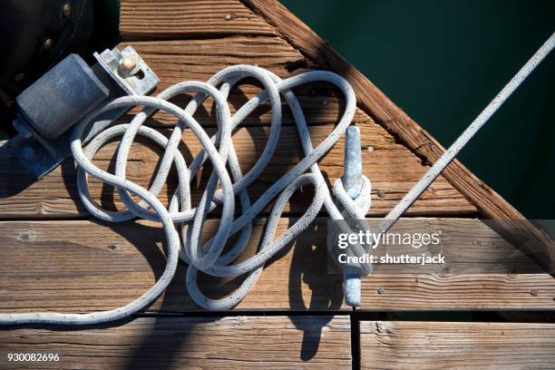 ropes tied to a cleat on a dock - wooden boat stock pictures, royalty-free photos & images