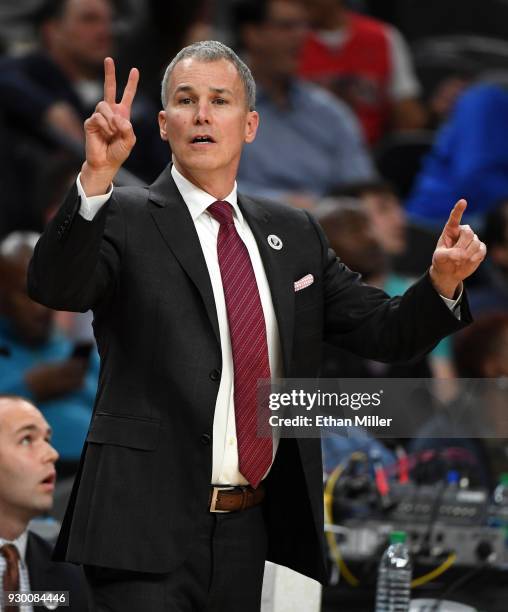 Head coach Andy Enfield of the USC Trojans signals to his players during a semifinal game of the Pac-12 basketball tournament against the Oregon...