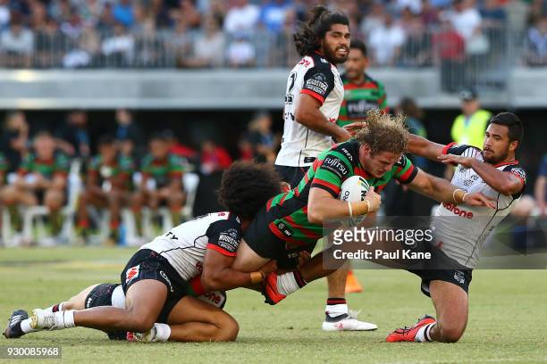 George Burgess of the Rabbitohs gets tackled during the round one NRL match between the South Sydney Rabbitohs and the New Zealand Warriors at Optus...