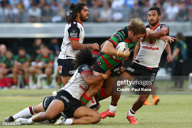 George Burgess of the Rabbitohs gets tackled during the round one NRL match between the South Sydney Rabbitohs and the New Zealand Warriors at Optus...