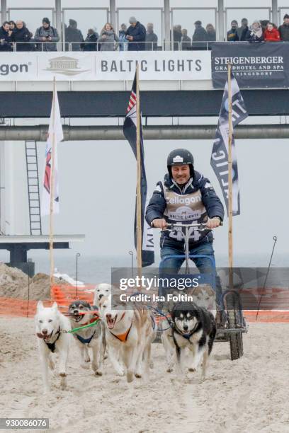 German actor Till Demtroeder runs with sled dogs during the 'Baltic Lights' charity event on March 10, 2018 in Heringsdorf, Germany. The annual event...