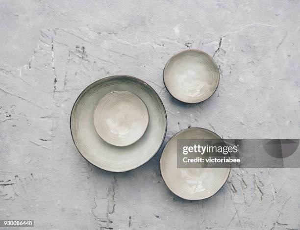 ceramic bowls on a textured background - bowl stock pictures, royalty-free photos & images