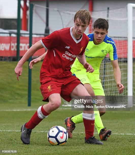 Niall Brookwell of Liverpool and Connor Minkley of Derby County in action during the U18 Premier League match between Liverpool and Derby County at...