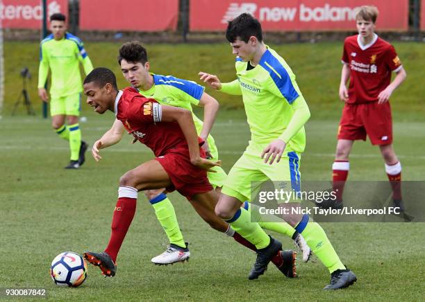 Elijah Dixon-Bonner of Liverpool and Henry Wise and Jack Stretton of Derby County in action during the U18 Premier League match between Liverpool and...