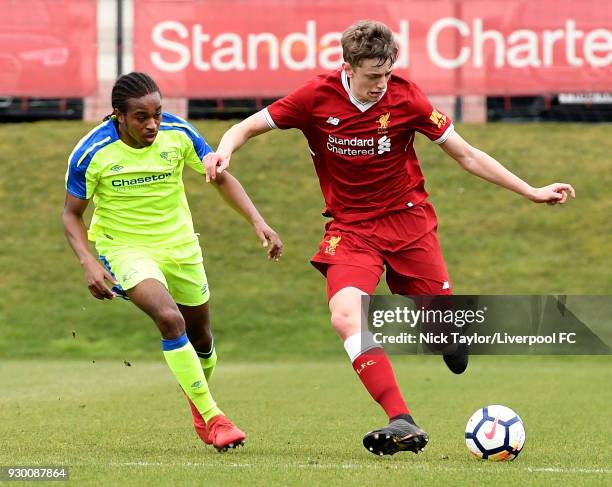 Tom Clayton of Liverpool and Francis Baptiste of Derby County in action during the U18 Premier League match between Liverpool and Derby County at The...
