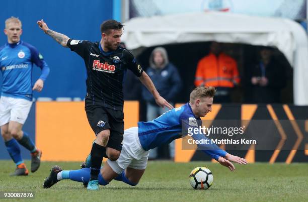 Willi Evseev of Rostock battles for the ball with Robin Krausse of Paderborn during the 3.Liga match between FC Hansa Rostock and SC Paderborn 07 at...