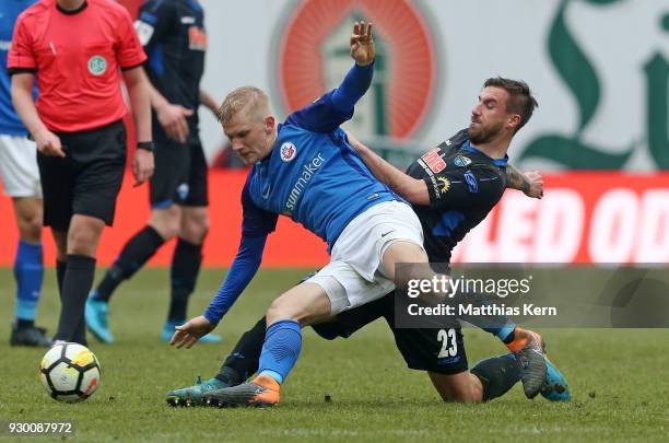Bryan Henning of Rostock battles for the ball with Robin Krausse of Paderborn during the 3.Liga match between FC Hansa Rostock and SC Paderborn 07 at...