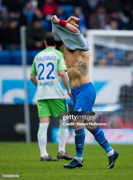 Eugen Polanski of Hoffenheim is removing his damaged jersey to replkace it with a new one during the Bundesliga match between TSG 1899 Hoffenheim and...