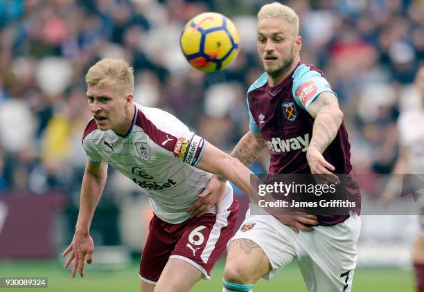 Marko Arnautovic of West Ham United in action with Ben Mee of Burnley during the Premier League match between West Ham United and Burnley at London...