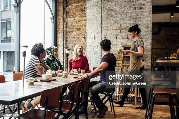 waitress serving customers in cafe - small business lunch stock pictures, royalty-free photos & images