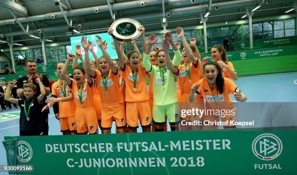 Anouk Blaschka of Hoffenheim lifts the winning trophy on the podium after the the final match between TSG 1899 Hoffenheim and DFC Westsachen Zwickau...