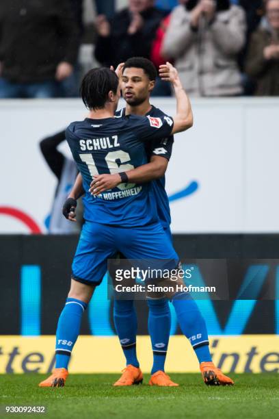 Serge Gnabry of Hoffenheim celebrates his team's second goal with team mate Nico Schulz during the Bundesliga match between TSG 1899 Hoffenheim and...