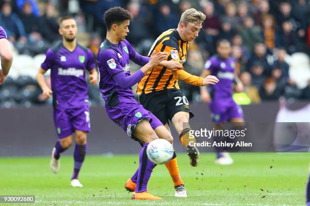 Jarrod Bowen of Hull City has a shot at goal as Jamal Lewis of Norwich City attempts to block it during the Sky Bet Championship match between Hull...