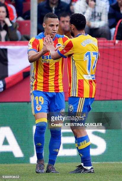 Valencia's Spanish forward Rodrigo Moreno celebrates with Valencia's French midfielder Francis Coquelin after scoring a goal during the Spanish...